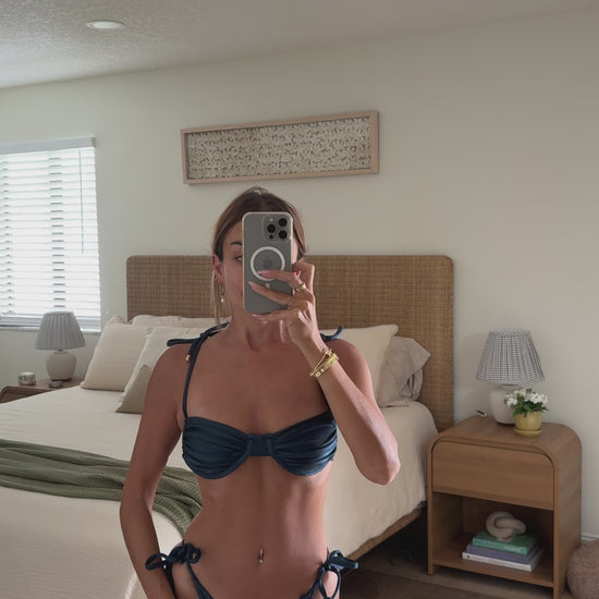 woman wearing luxury soft satin navy two-piece swimsuit bikini set